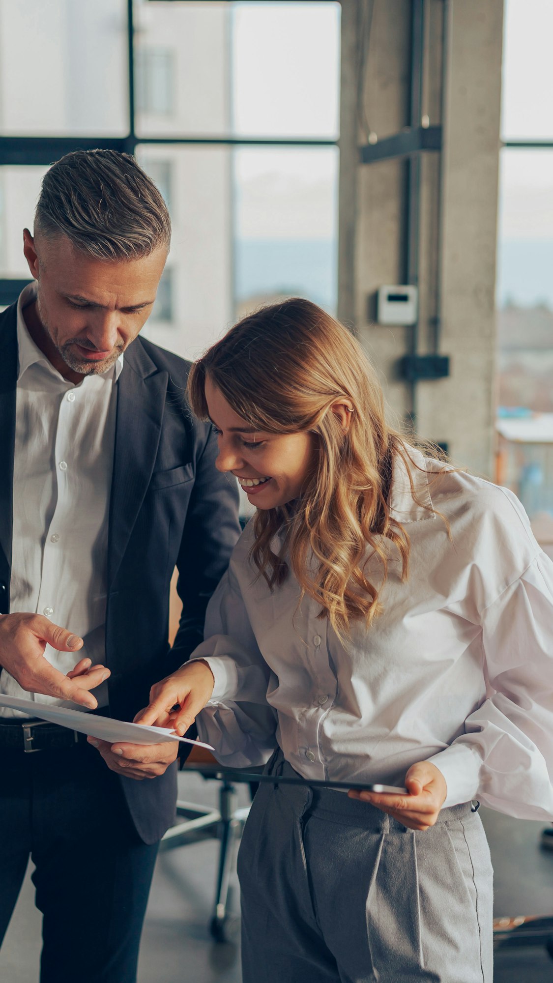Two professional executives experts discussing financial accounting papers working together